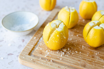 Making preserved Moroccan lemon with lemons and salt.
