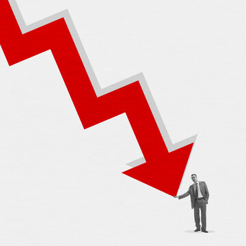 Young man near huge red arrow as indicator of fall in the exchange rate, decrease in standard of living of population. Global crisis problems