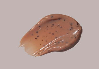 Scrub cream swatch smear smudge on brown color background.