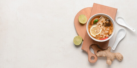 Fototapeta na wymiar Bowl of tasty Thai soup on light background with space for text