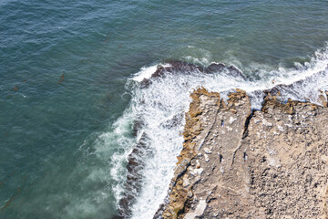 Aerial view of waves splashing on beach