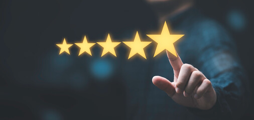 Businessman touching glowing yellow five stars for excellent evaluate after customer use product...