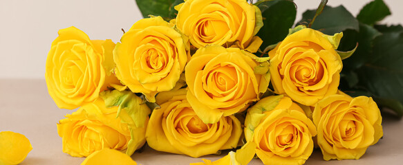 Bouquet of beautiful yellow roses on light background