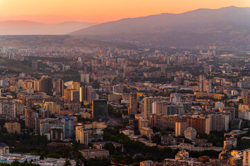 Aerial view of modern skyscrapers and luxurious buildings in downtown Tbilisi, Georgia, with sunset background - Europe landscape
