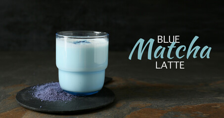 Glass of blue matcha tea on dark grunge background