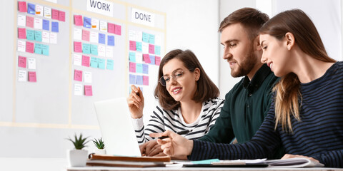 Young business people with laptop working in office. Agile concept