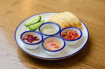 bread, cucumbers and salad ingredients in plates