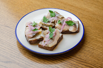 a sandwich with herring and onions
