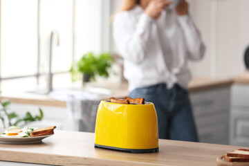 Modern toaster on kitchen table