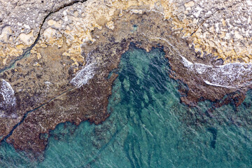 Aerial view of waves splashing on beach