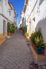 Street in the old town of the fortified city of Elvas (World Heritage Site by UNESCO) with its traditional white facades. Alentejo region, Portugal.