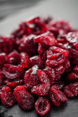 dried cranberry berry on a black wooden rustic background