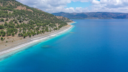 Blue waters and volcanic peebles of magical Salda Lake in Burdur, Turkey.