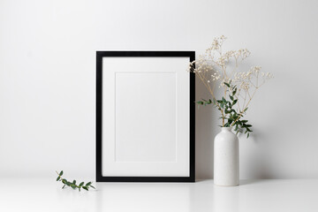 Frame mockup in white minimalistic interior with flowers decorations