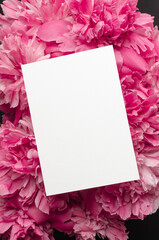 Invitation or greeting card mockup with pink peony flowers
