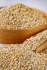 white quinoa seeds on a white acrylic background