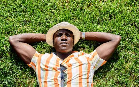 Black man lying on lawn