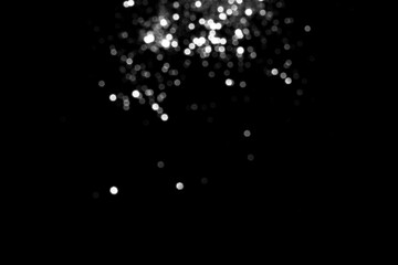 White gray blurred bokeh lights on black background. Glitter sparkle stars for celebrate. Overlay for your design