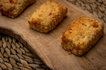 home made cheese  scones  on a wooden chopping board