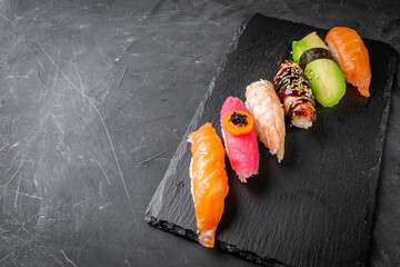 delicious sushi on a black stone background © Narsil