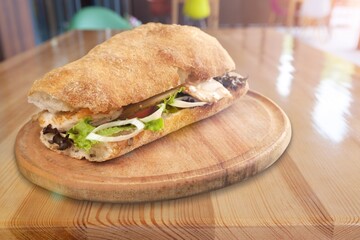 Tasty fresh sandwich made with cheese and onions on a wooden board