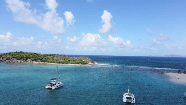 Deserted island in the Caribbean with boats and blue water