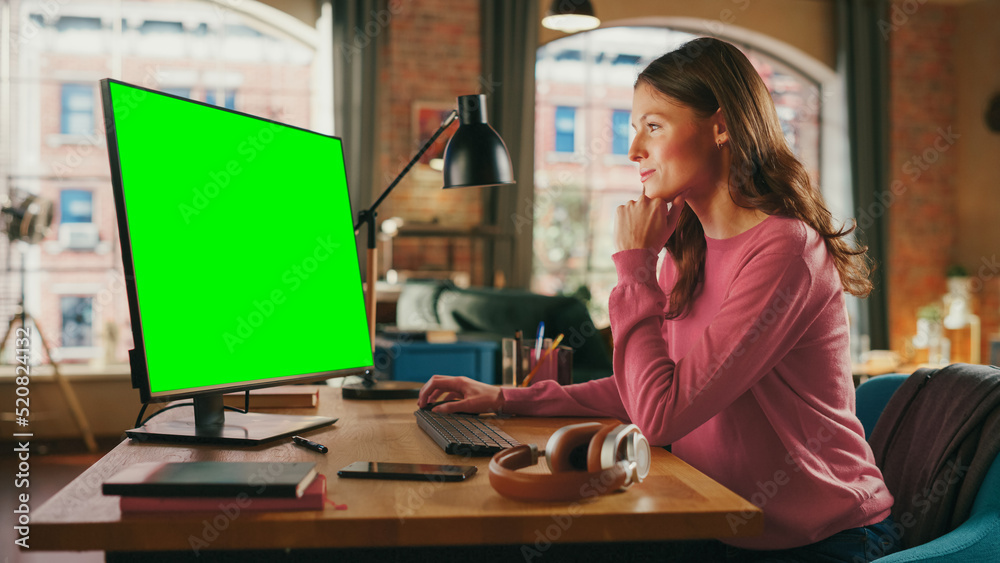 Aufkleber young pretty female working from home on desktop computer with green screen mock up display. creativ