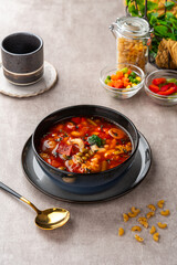 Minestrone Soup is a thick soup of Italian origin made with vegetables, often with the addition of pasta or rice.