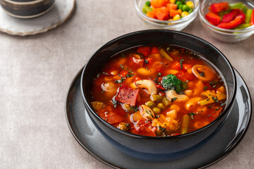 Minestrone Soup is a thick soup of Italian origin made with vegetables, often with the addition of pasta or rice.