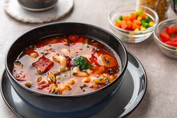 Minestrone Soup is a thick soup of Italian origin made with vegetables, often with the addition of pasta or rice.