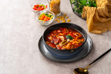 Minestrone Soup is a thick soup of Italian origin made with vegetables, often with the addition of pasta or rice.