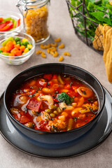 Minestrone Soup is a thick soup of Italian origin made with vegetables, often with the addition of pasta or rice.