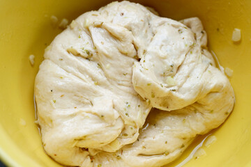 Dough mixed with chopped garlic and herb after Kneaded in a mixing bowl