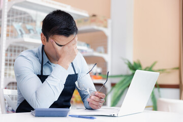 Male entrepreneur store owner feel stressful regret and sad in business crisis during covid pandemic