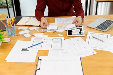 UX UI Concept, Graphic designers work together with UX UI designer planning application template layout framework for mobile phone computer mobile