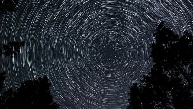 Comet-shaped star trails in the night sky
