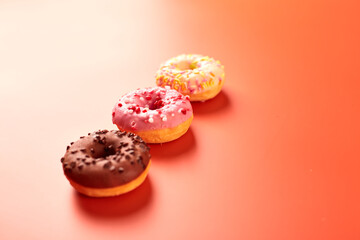 colorful donuts on purple background. Copy space