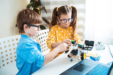 Shot of young brother and sister enjoying spending time together building a robot, children happiness vitality lifestyle enjoyment educational scientific activity learning skilled