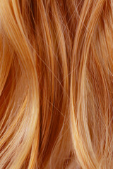 Red curly hair texture closeup. Red hair background.