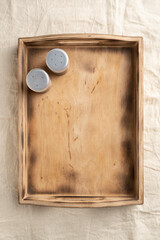 Empty wooden serving box with handles with spices and cutlery. Food and catering concept. Open container for food
