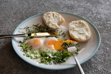 Fried eggs with greens close-up, healthy breakfast