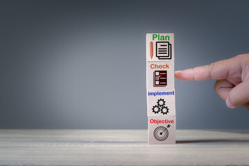 Concept of business strategy and action plan. Wood cube block stack on text and icon