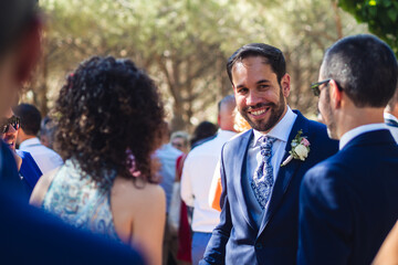 groom on his wedding day greets guests