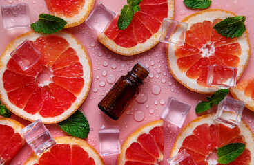 Grapefruit essential oil in a bottle. Selective focus.