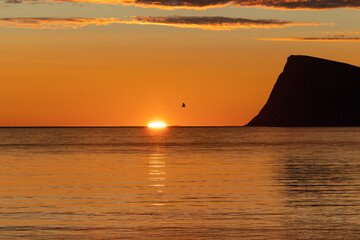 beautiful atmosphere of midnight sun at Sommaroy island (Sommarøy) with Haja (Håja) island in the...
