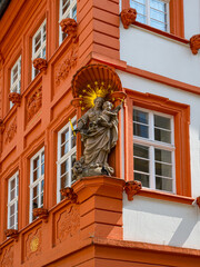 City view of Heidelberg showing a historic house facade including a christian figure. Baden...