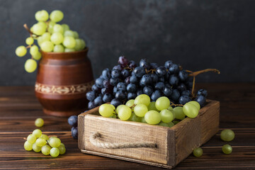 fresh juicy grapes in wooden box on table