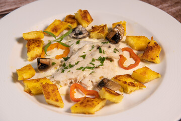 Recipe for sea bass fillet with fried polenta and white wine sauce. High quality photo