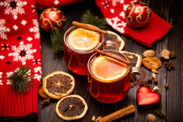 Obraz na płótnie Canvas Fruity mulled wine on a wooden background with spices.