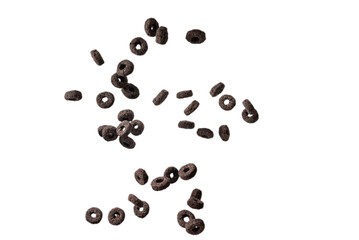 Chocolate rings cereal spill out into a bowl. Breakfast.